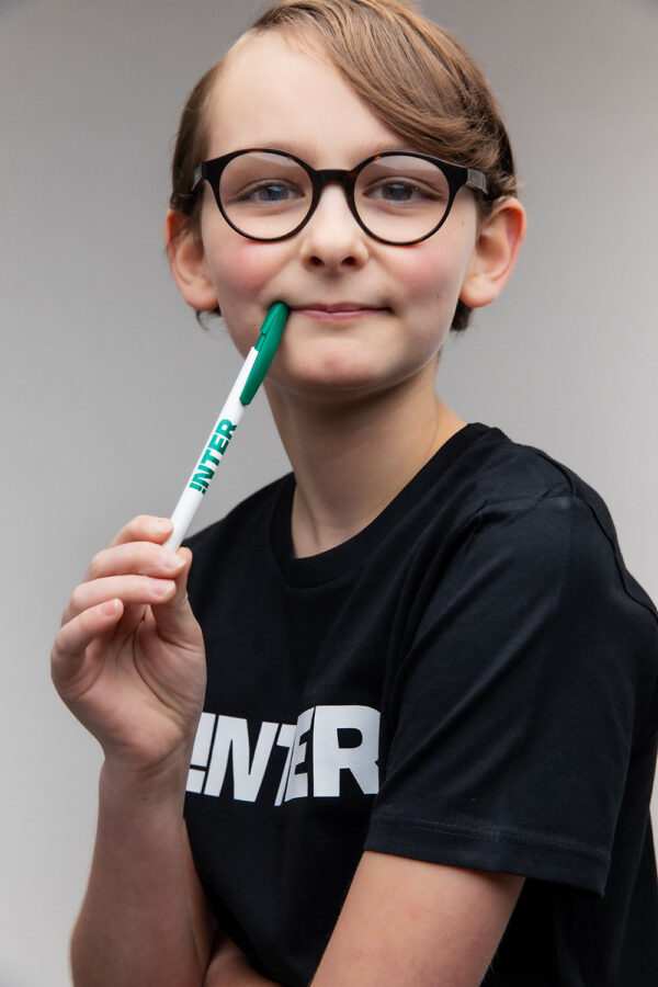 Image of a boy holding an iNTER pen in his hand